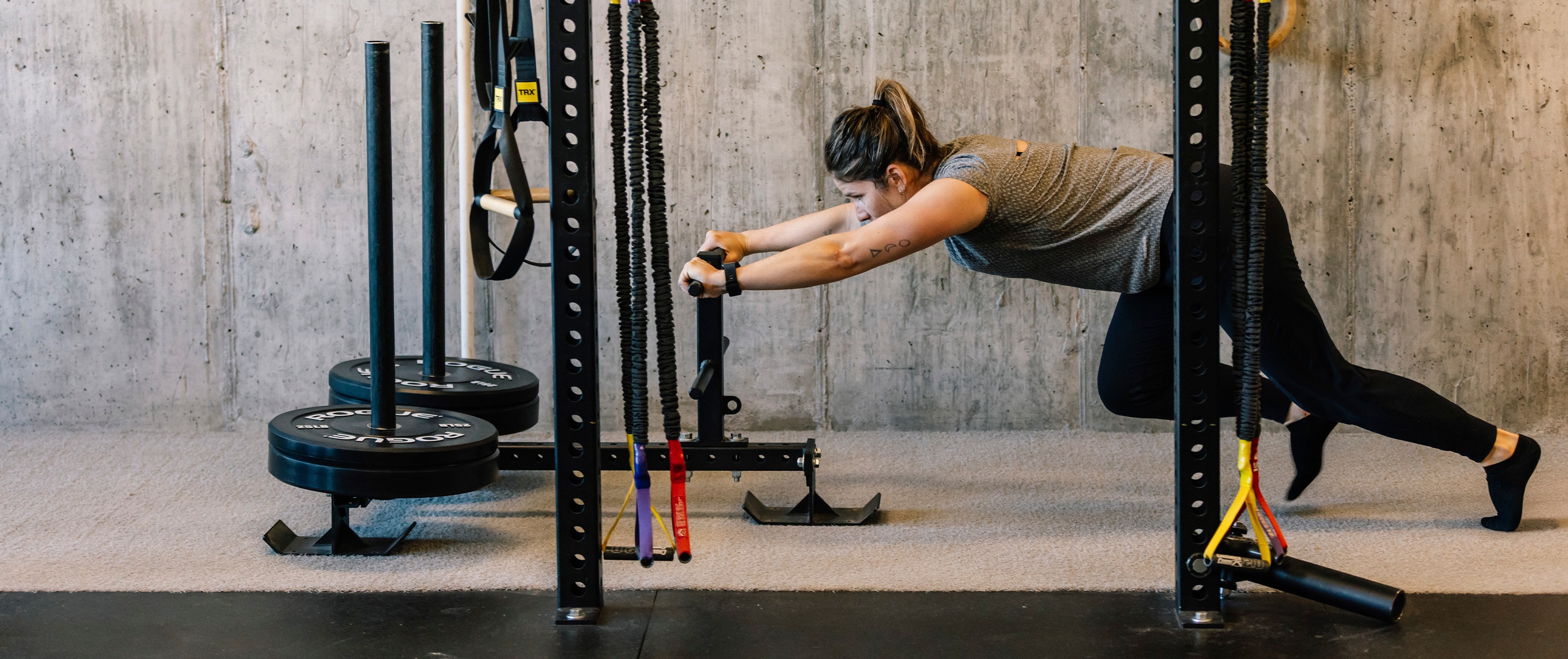 Wildfire Gym Member pushing a sled fitness workout