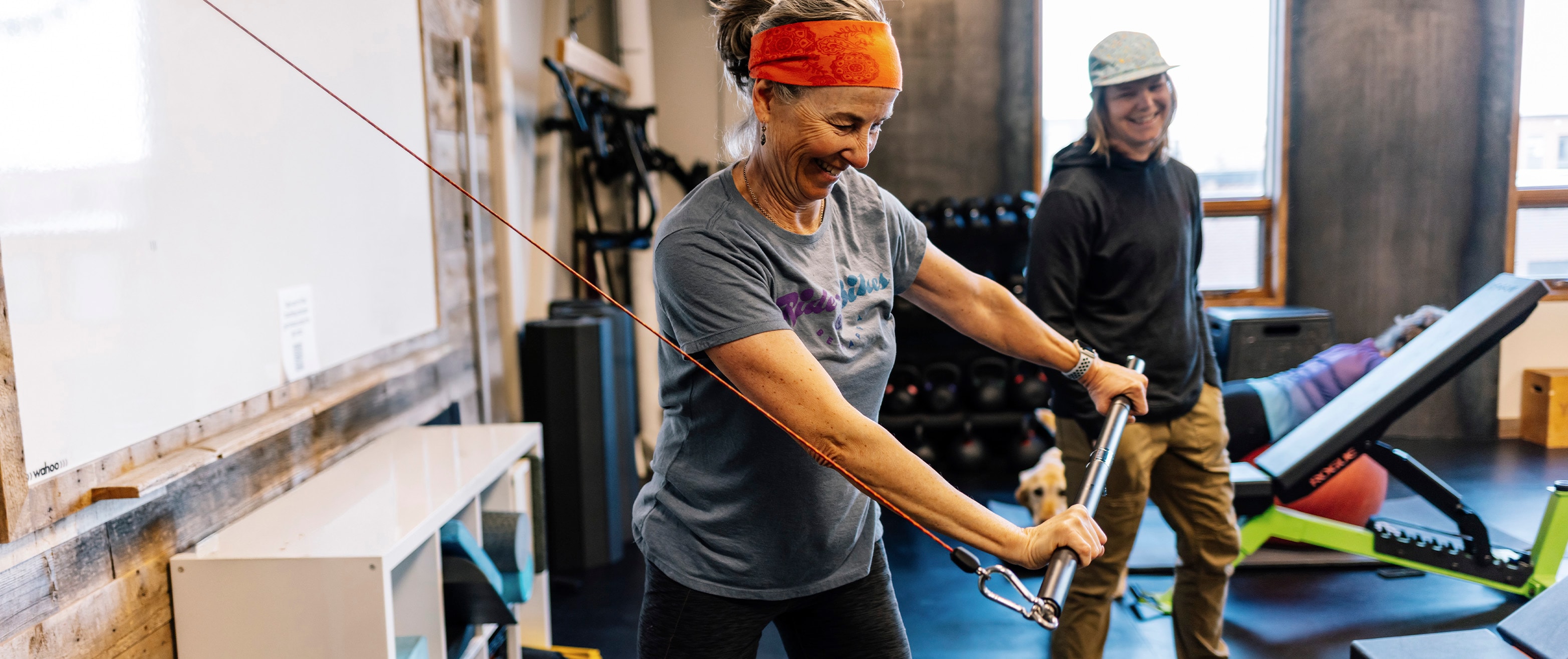 Coach lacey helps client at wildfire fitness with technique and strength training