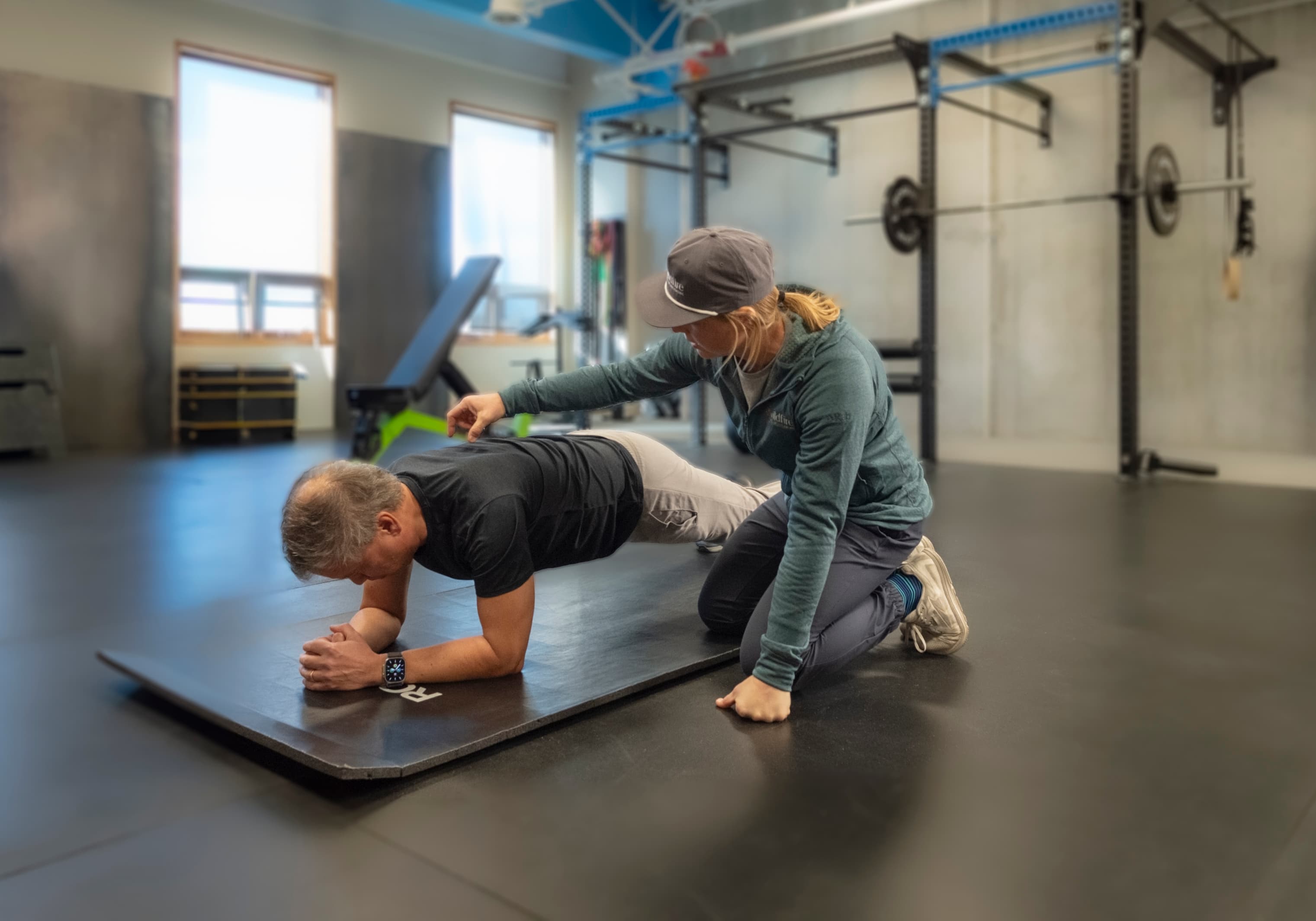 Lacey doing a physical assessment for a client at Wildfire Coaching