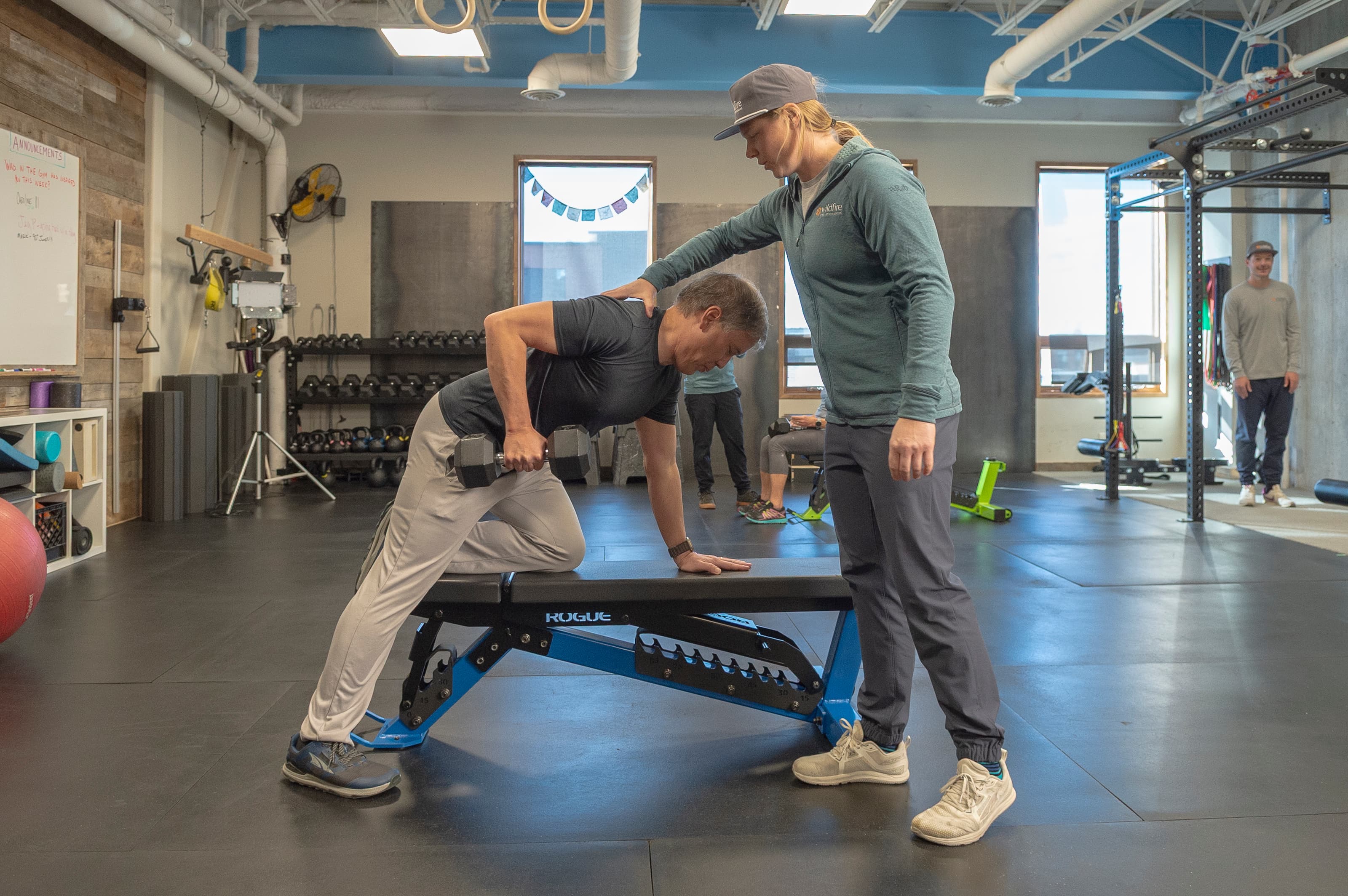 Coach Lacey Working with gym member on long term fitness goals